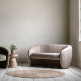 Modern beige sofa in a minimalistic room with a neutral color palette.
